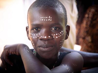 Intergenerational learning is a core part of the process in Tharaka. Elijah Mutwiri is in Grade 9. His face is marked as part of the rite of passage for boys with a paint extracted from a sacred stone known as ira. Photo: Rory Sheldon